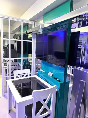 a room with a table and two white chairs at One-bedroom condo at Shell Residences in Manila