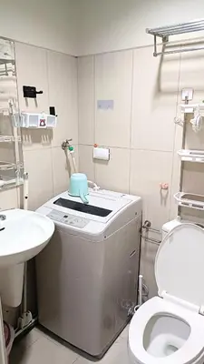 a bathroom with a toilet and a sink at Spacious simple one-bedroom condo at Shell Residence in Manila