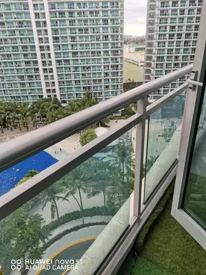 a balcony with a view of a beach and buildings at Azure Urban Resort Residences in Manila