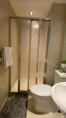 a bathroom with a toilet and a sink at Azure Urban Resort Residences in Manila