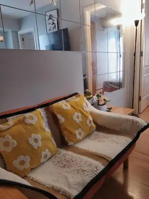 a couch with pillows on it in a living room at Azure Urban Resort Residences in Manila