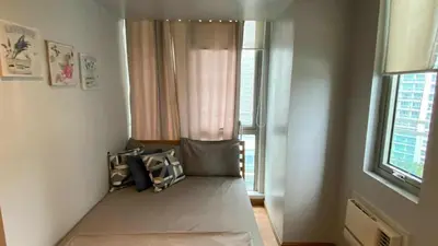 a room with a bed in front of a window at Azure Urban Resort Residences in Manila