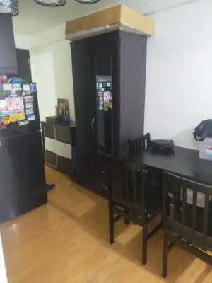 a kitchen with a refrigerator and a table and chairs at May homey vibe in Pasig