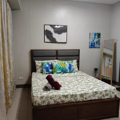 a bed with two pillows and a blanket at LDN Secret Crib 5K- Two Palm Tree in Manila