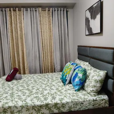 a bed with two pillows on it in a bedroom at LDN Secret Crib 5K- Two Palm Tree in Manila
