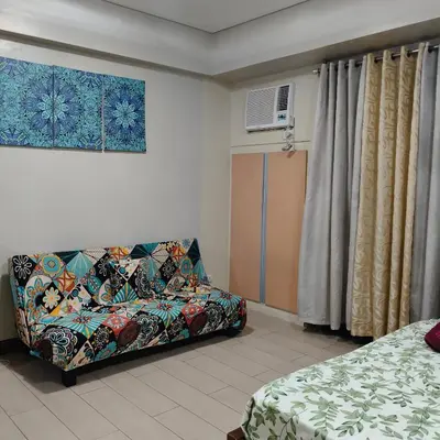 a living room with a couch and a bed at LDN Secret Crib 5K- Two Palm Tree in Manila