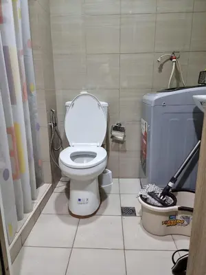 a bathroom with a toilet and a sink at Apartment Condo Unit 1-br Self-contained in Manila