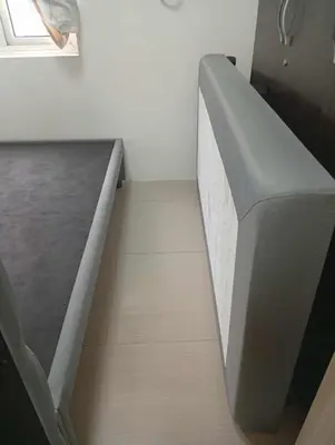 a staircase in a room with a gray couch at Apartment Condo Unit 1-br Self-contained in Manila