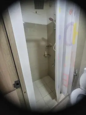 a bathroom with a shower with a shower curtain at Apartment Condo Unit 1-br Self-contained in Manila