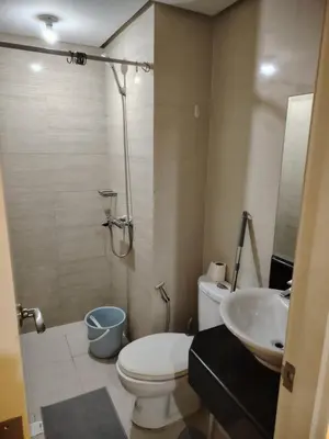 a bathroom with a toilet and a sink and a shower at Cheap Accommodation - Newport Boulevard in Manila