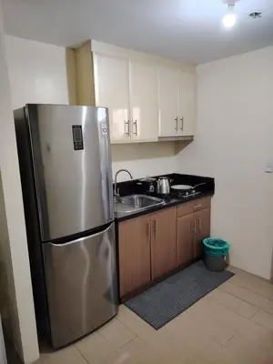 a kitchen with a stainless steel refrigerator and a sink at Cheap Accommodation - Newport Boulevard in Manila