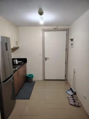 a kitchen with a door leading to a kitchen with a floor at Cheap Accommodation - Newport Boulevard in Manila