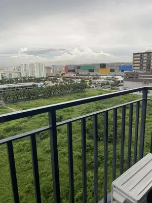 a balcony with a bench and a view of a city at Dona staycation in Manila