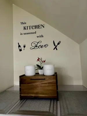 a room with three plants and butterflies on a wall at Miyu's Staycation Place in Biñan