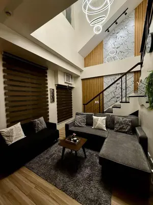 a living room with a couch and a table at Miyu's Staycation Place in Biñan