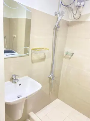 a bathroom with a sink and a shower at SHORE 2 tower 2 in Manila