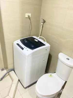a bathroom with a white toilet and a sink at SHORE 2 tower 2 in Manila
