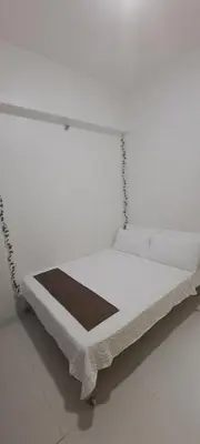 a white bed frame with a white mattress at Soap's Haven Rental Unit in Paranaque in Manila