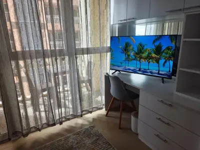 a room with a desk with a tv and a window at Modern Bright Cozy Stylish 1BR Venice BGC Balcony in Manila