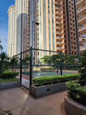 a fence in the middle of a city with tall buildings at Modern Bright Cozy Stylish 1BR Venice BGC Balcony in Manila