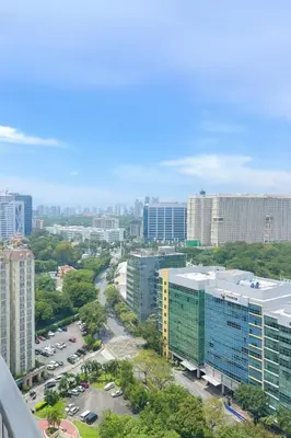 an aerial view of a city with tall buildings at Cozy & Spacious 2BR Stay Near BGC - Home Theater in Manila