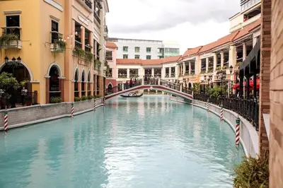 a canal in a city with buildings and a bridge at Cozy & Spacious 2BR Stay Near BGC - Home Theater in Manila