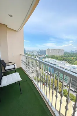 a balcony with a bench and a view of the city at Cozy & Spacious 2BR Stay Near BGC - Home Theater in Manila