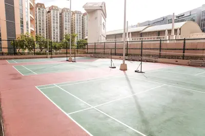 two tennis courts in a city with tall buildings at Cozy & Spacious 2BR Stay Near BGC - Home Theater in Manila