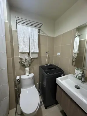 a bathroom with a toilet and a sink at JM's CRIB in Manila