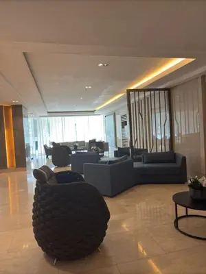 a lobby with couches and chairs in a building at JM's CRIB in Manila