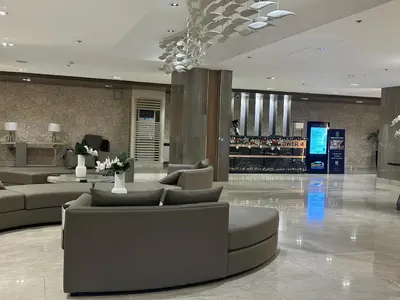 a lobby with couches and a bar in a building at JM's CRIB in Manila