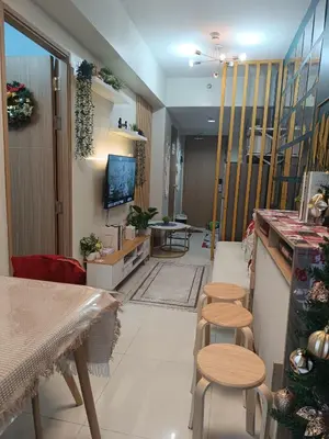 a living room with stools and a dining room at SkyShore Suites in Manila