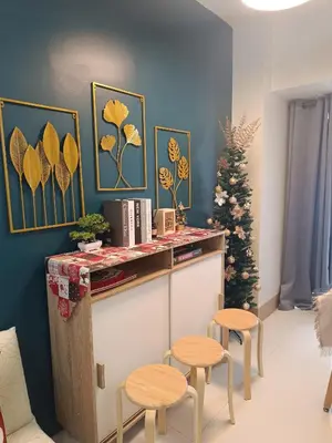 a room with a counter with stools and a christmas tree at SkyShore Suites in Manila