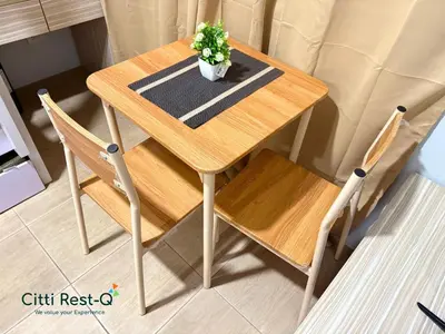 a wooden table with two chairs and a potted plant on it at Studio City Alabang Pool Access Free for 2 Wifi & Netflix SC5 in Manila