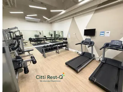 a gym with treadles and ellipticals in a room at Studio City Alabang Pool Access Free for 2 Wifi & Netflix SC5 in Manila