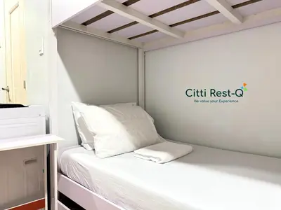a small bed in a room with a sign on the wall at Studio City Alabang Pool Access Free for 2 Wifi & Netflix SC5 in Manila