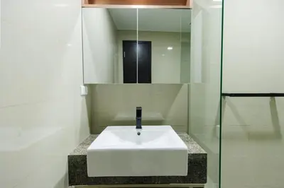 a bathroom with a white sink and a mirror at cityscapethe39th at Eastwood Global Plaza - Luxury Residences in Manila