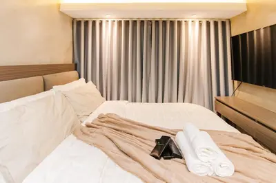 a bedroom with a bed with two towels on it at cityscapethe39th at Eastwood Global Plaza - Luxury Residences in Manila