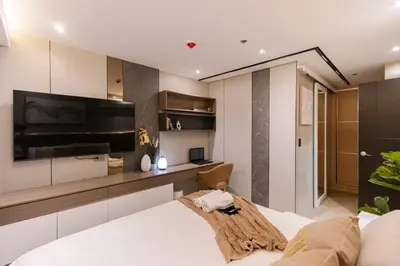 a bedroom with a bed and a flat screen tv at cityscapethe39th at Eastwood Global Plaza - Luxury Residences in Manila
