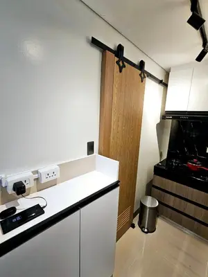 a kitchen with a stove and a white counter top at Brand New 2 Bedder near Malls SMDC Bloom in Manila