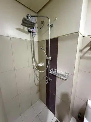 a shower in a bathroom with a glass door at Pocco-breeze- inhouse pool in Manila