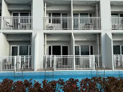 a building with balconies and a swimming pool at Pocco-breeze- inhouse pool in Manila