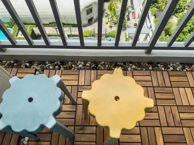 a pair of wooden dog heads on a balcony at Unique and Quiet Studio Unit in Mandaluyong or Makati with Fast WiFi & Best City View in Manila
