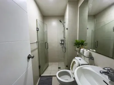a bathroom with a shower and a toilet and a sink at Unique and Quiet Studio Unit in Mandaluyong or Makati with Fast WiFi & Best City View in Manila