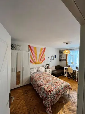 a bedroom with a bed and a living room at Becca's double bedroom alongside Metrobank Makati in Manila