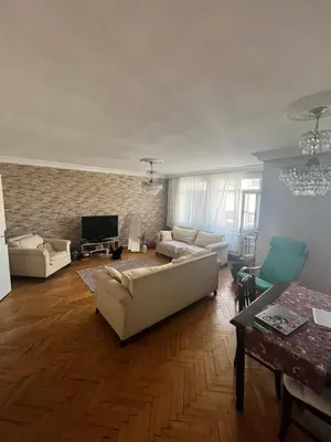 a living room with white couches and a brick wall at Becca's double bedroom alongside Metrobank Makati in Manila