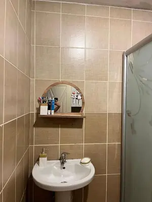 a bathroom with a sink and a mirror at Becca's double bedroom alongside Metrobank Makati in Manila