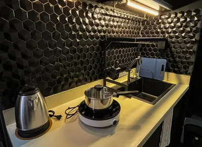 a kitchen counter with a blender and a sink at Dibuho Studio in Manila