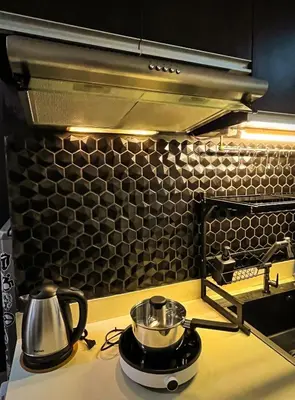a kitchen with two pots and pans on a stove at Dibuho Studio in Manila