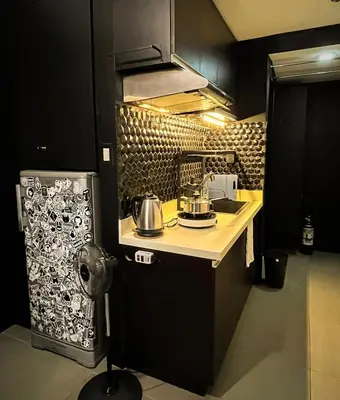 a kitchen with a counter with a tea kettle on it at Dibuho Studio in Manila